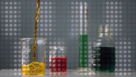 Animation-of-moving-grey-dots-over-liquid-pouring-into-lab-glass