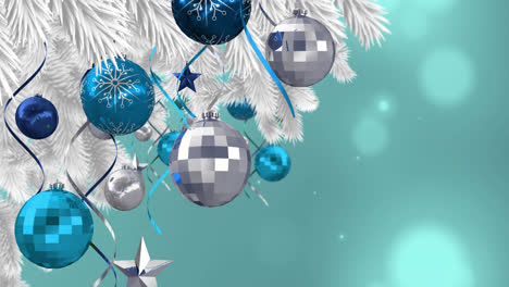 Animation-of-baubles-hanging-on-christmas-tree-on-blue-background-with-lights