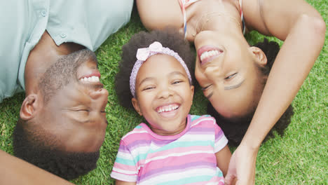 Portrait-of-happy-african-american-couple-with-their-daughter-playing-in-garden