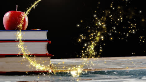 Animation-of-glowing-shooting-star-over-apple-on-stack-of-books