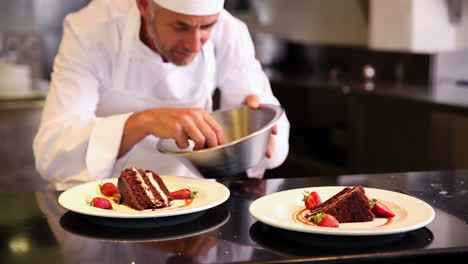 Chef-putting-strawberries-onto-chocolate-cake
