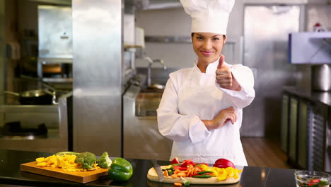 Chef-preparing-vegetables-and-smiling-at-camera