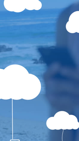 Animation-Von-Wolken-Mit-Elektronischen-Geräten-über-Einer-Kaukasischen-Frau,-Die-Ihr-Smartphone-Benutzt