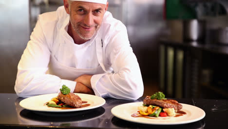 Happy-chef-showing-two-beef-dishes-