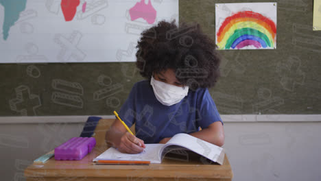 Animation-of-school-icons-over-african-american-schoolboy-wearing-face-mask