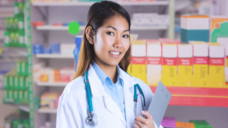 Animation-of-smiling-asian-female-doctor-with-clipboard-over-blue-ribbon