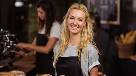 Smiling-young-caucasian-female-chef-preparing-food-in-professional-kitchen