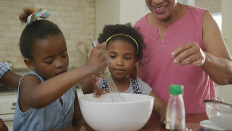 Glückliche-Afroamerikanische-Großeltern-Mit-Enkelinnen-Beim-Backen-In-Der-Küche