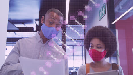 Animation-of-dna-rotating-over-african-american-man-and-woman-in-face-mask-in-office