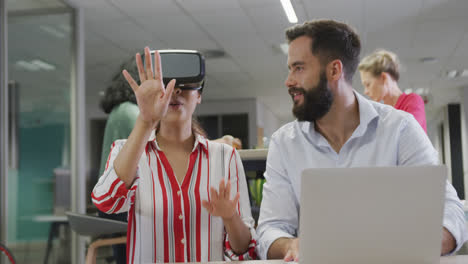 Happy-diverse-male-and-female-business-colleagues-using-vr-headset-in-office