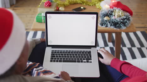 African-american-mother-and-adult-daughter-on-laptop-christmas-video-call,-copy-space,-slow-motion