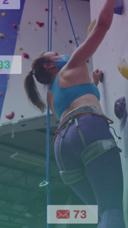 Animation-of-media-icons-over-caucasian-woman-with-face-mask-on-climbing-wall