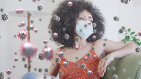 Animation-of-virus-cells-over-african-american-woman-with-face-mask