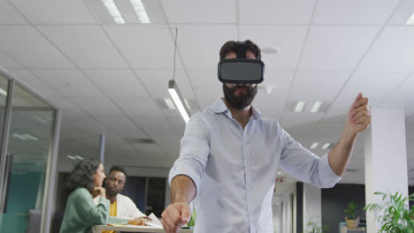 Glücklicher-Biracial-Geschäftsmann,-Der-VR-Headset-Gegenüber-Kollegen-Im-Büro-Verwendet