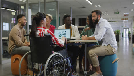 Happy-diverse-male-and-female-business-colleagues-and-disabled-businesswoman-talking-in-office