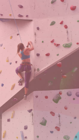 Abstract-colorful-shapes-against-caucasian-fit-woman-wall-climbing-at-the-gym