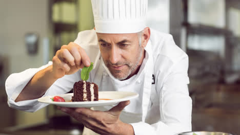 Smiling-caucasian-male-chef-wearing-apron-preparing-food-in-professional-kitchen