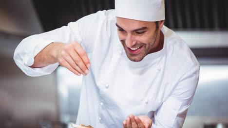 Smiling-caucasian-male-chef-wearing-apron-preparing-food-in-professional-kitchen