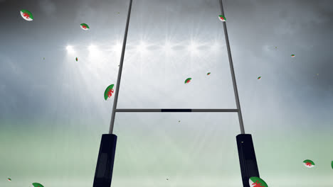 Animation-of-rugby-balls-coloured-with-flag-of-wales-at-stadium