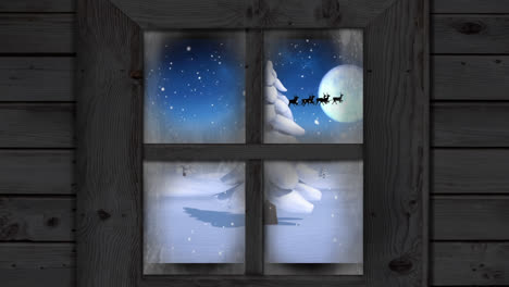 Animation-of-snow-over-santa-claus-in-sleigh-with-reindeer-in-winter-scenery-seen-through-window