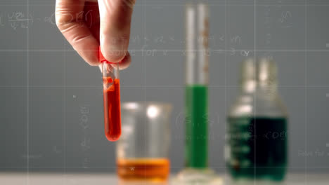 Animation-of-scientific-data-over-hand-of-lab-worker-holding-glass-with-reagent