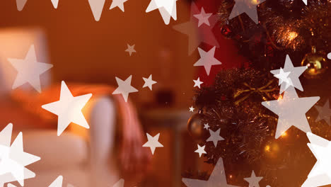 Animation-of-christmas-stars-falling-over-blurred-background