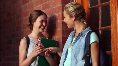Classmates-standing-in-hallway-chatting