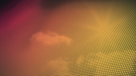 Animation-of-yellow-to-orange-rows-of-spots-over-clouds-in-background
