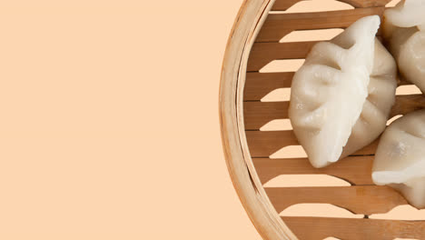 Close-up-of-dumplings-in-bowl-on-beige-background