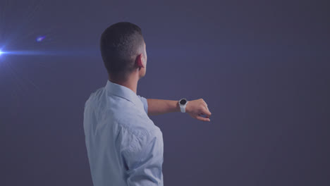 Animation-of-caucasian-businessman-using-smartwatch-over-glowing-light-on-blue-background