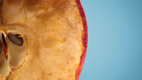 Close-up-of-half-an-apple-on-blue-background