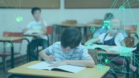 Animation-of-globe-of-digital-icons-against-caucasian-boy-studying-in-the-class-at-school