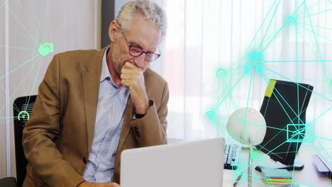 Animation-of-globes-of-digital-icons-spinning-over-thoughtful-caucasian-man-using-laptop-at-office