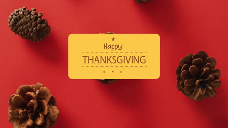 Animation-of-happy-thanksgiving-day-over-pine-cones-on-red-background