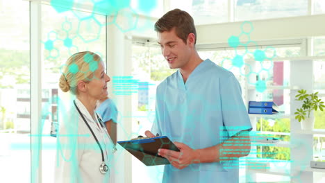 Animation-of-medical-data-processing-over-caucasian-male-and-female-doctors-discussing-at-hospital