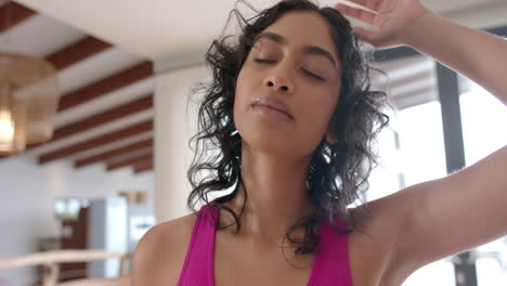 Biracial-woman-doing-yoga-and-stretching-at-home,-slow-motion