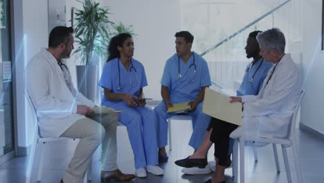 Animation-of-heart-rate-montior-against-team-of-diverse-doctors-discussing-together-at-hospital