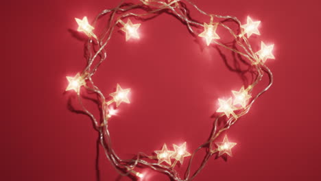 Video-of-fairy-lights-christmas-decorations-with-copy-space-on-red-background