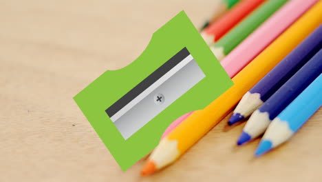 Colorful-pencils-are-arranged-on-a-wooden-surface,-with-copy-space