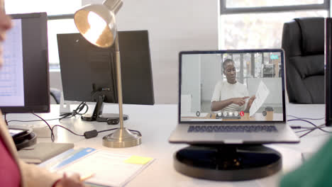 Laptop-with-video-call-with-african-american-businesswoman-on-screen