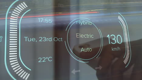 Animation-of-electric-car-dashboard-data-processing-against-close-up-of-a-hand-holding-a-smartphone