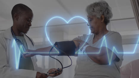 Animation-of-cardiograph-and-heart-over-diverse-senior-female-patient-and-doctor-taking-pressure