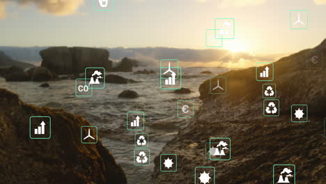 Animation-of-green-energy-concept-icons-floating-against-view-of-rocks-and-the-sea