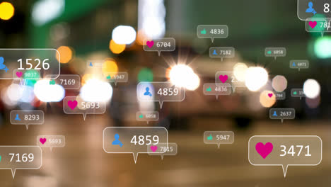 Animation-of-social-media-icons-against-blurred-view-of-people-walking-on-the-street-at-night