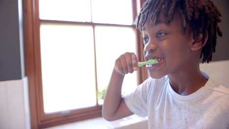 Afroamerikanischer-Junge-Putzt-Sich-Zu-Hause-Im-Badezimmer-Die-Zähne,-Zeitlupe