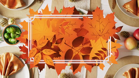 Animation-of-white-frame-and-autumn-leaves-over-thanksgiving-dinner-background