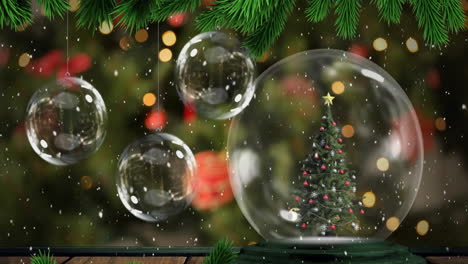 Animation-of-branch-and-snow-falling-on-christmas-tree-in-a-snowglobe-and-hanging-bauble-decorations