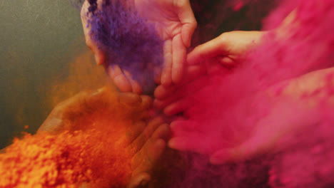 Video-of-multi-coloured-powders-over-hands-with-copy-space
