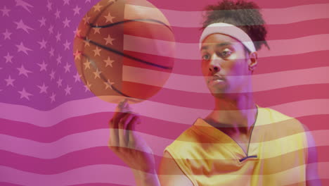 Animation-of-american-flag-over-african-american-male-basketball-player-spinning-ball