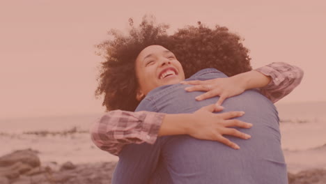 Happy-african-american-couple-hugging-each-other-at-the-beach